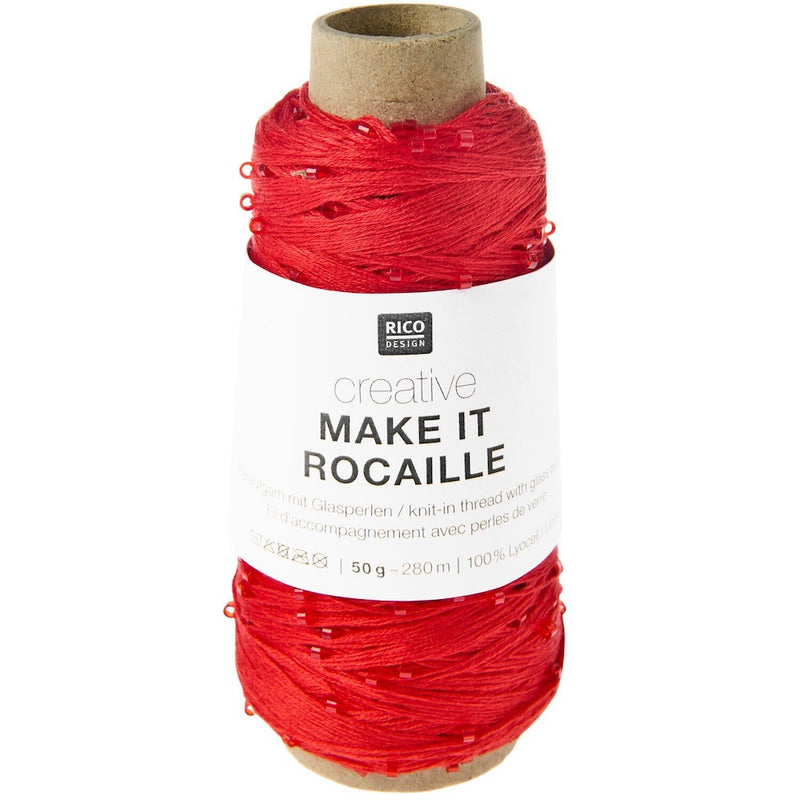 A spool of red knitted thread with a white paper label reading 'RICO DESIGN creative MAKE IT ROCAILLE' on a plain white background.
