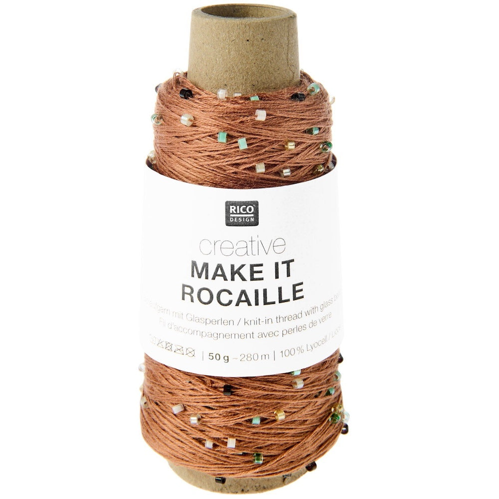 A spool of Rico Design creative 'Make It Rocaille' glass pearl thread, wound on a brown cardboard core with a white paper label, set against a plain white background.